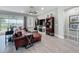 Comfortable living room with wood-look tile flooring, a ceiling fan, and sliding glass doors with lake views at 224 Silver Maple Rd, Groveland, FL 34736