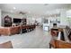 Spacious open floor plan with a living room, kitchen, dining area, and wood-look tile flooring throughout at 224 Silver Maple Rd, Groveland, FL 34736