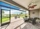 Screened-in patio with a brick floor, ceiling fan, and a view of the lake beyond at 224 Silver Maple Rd, Groveland, FL 34736