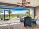 Screened patio with brick flooring and view of a grassy yard overlooking a small lake at 224 Silver Maple Rd, Groveland, FL 34736