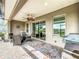 Screened patio with brick flooring and view of a grassy yard overlooking a small lake at 224 Silver Maple Rd, Groveland, FL 34736