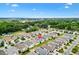 Scenic aerial shot capturing a residential area with mature trees and a distant lake at 2457 Upton St, The Villages, FL 32163