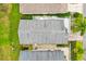 Aerial view of the home's roof, showcasing its design, along with the backyard and surrounding foliage at 2457 Upton St, The Villages, FL 32163