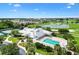 An aerial view of the community pool, tennis courts, and golf course at 2457 Upton St, The Villages, FL 32163