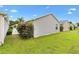 Lush backyard featuring well-maintained grass and tidy landscaping, offering a serene outdoor space at 2457 Upton St, The Villages, FL 32163