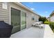 Outdoor patio featuring a picnic table, charcoal grill, and access to the home via sliding glass doors at 2457 Upton St, The Villages, FL 32163