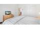 Bright bedroom featuring a comfortable bed, closet, and a neutral color scheme at 2457 Upton St, The Villages, FL 32163