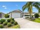 Charming single-story home with a two-car garage, landscaped front yard, and inviting curb appeal at 2457 Upton St, The Villages, FL 32163