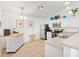 Stylish kitchen with stainless steel appliances, white cabinets, and breakfast bar seating at 2457 Upton St, The Villages, FL 32163