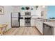 Bright kitchen with white cabinets, stainless steel appliances, and modern fixtures at 2457 Upton St, The Villages, FL 32163