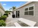 Cozy back patio area with outdoor seating, plants, and a grill, perfect for entertaining guests at 2457 Upton St, The Villages, FL 32163