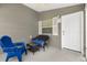 Relaxing covered porch with comfortable seating, a ceiling fan, and neutral gray siding at 2457 Upton St, The Villages, FL 32163