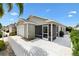 The backyard features a screen enclosed patio and a well maintained white fence at 2457 Upton St, The Villages, FL 32163