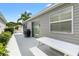 Outdoor patio featuring a picnic table, charcoal grill, and access to the home via sliding glass doors at 2457 Upton St, The Villages, FL 32163