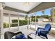 Relaxing screened porch with chairs, a ceiling fan, and bright natural lighting at 2457 Upton St, The Villages, FL 32163