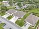 This aerial shows beautiful single-Gathering homes with well-manicured lawns in a community near a golf course and clubhouse at 27215 White Plains Way, Leesburg, FL 34748