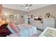 Comfortable bedroom with soft decor, a large bed, and a view into the ensuite bathroom at 27215 White Plains Way, Leesburg, FL 34748