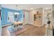 Bright dining room with wooden table, chairs, rug, colorful decor, and blue accent wall at 27215 White Plains Way, Leesburg, FL 34748