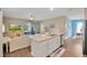 Open-concept kitchen with gray countertops, stainless steel appliances, and connects to living room and dining area at 27215 White Plains Way, Leesburg, FL 34748