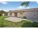 The home's backyard features a patio, grassy area, and striped awning at 2744 Gresham Ave, The Villages, FL 32162