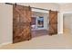 Rustic barn doors leading into bright sunroom at 2744 Gresham Ave, The Villages, FL 32162