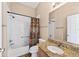 Bright bathroom featuring a tub with shower and granite counters at 2744 Gresham Ave, The Villages, FL 32162