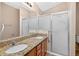 Bathroom with double sink vanity and glass shower doors at 2744 Gresham Ave, The Villages, FL 32162