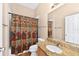 Bright bathroom featuring a tub with shower and granite counters at 2744 Gresham Ave, The Villages, FL 32162
