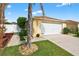 Charming home with a two-car garage, complemented by a well-manicured lawn and established landscaping at 2744 Gresham Ave, The Villages, FL 32162
