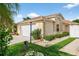 Well-kept home with a two-car garage, complemented by a manicured lawn and mature landscaping at 2744 Gresham Ave, The Villages, FL 32162