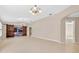 Open-concept living area with tile flooring and barn door access to Florida room at 2744 Gresham Ave, The Villages, FL 32162