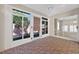 Enclosed sunroom featuring brick floors, light walls, and multiple windows to the exterior at 2744 Gresham Ave, The Villages, FL 32162