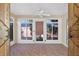 Enclosed sunroom featuring brick floors, light walls, and multiple windows to the exterior at 2744 Gresham Ave, The Villages, FL 32162
