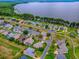 Neighborhood aerial view showcasing a lakeside community with beautiful waterfront homes and lush landscaping at 3001 Lake Huron Ln, Tavares, FL 32778