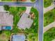 Bird's eye view showing the property lines, mature landscaping, screened patio and driveway at 3001 Lake Huron Ln, Tavares, FL 32778