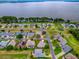 Aerial view of this single Gathering home with lake views and surrounded by lush landscaping at 3001 Lake Huron Ln, Tavares, FL 32778