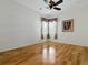 Bright bedroom with wood floors, window with curtains and wall art at 3001 Lake Huron Ln, Tavares, FL 32778