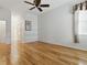 Bedroom featuring wood floors, window with blinds, and access to the hallway at 3001 Lake Huron Ln, Tavares, FL 32778