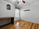 Bright bedroom includes beautiful wood floors, a ceiling fan, and a desk at 3001 Lake Huron Ln, Tavares, FL 32778