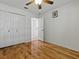 This bedroom has wood floors, ceiling fan, closet, and access to the bathroom at 3001 Lake Huron Ln, Tavares, FL 32778