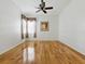 Bright bedroom featuring hardwood floors, a ceiling fan, and a large window at 3001 Lake Huron Ln, Tavares, FL 32778