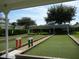 A scenic bocce ball court invites leisurely afternoons in lush, green surroundings under clear blue skies at 3001 Lake Huron Ln, Tavares, FL 32778