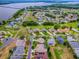 Aerial view of a lakefront community with lush landscaping, roadways, greenways and serene lake views at 3001 Lake Huron Ln, Tavares, FL 32778