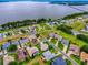 Aerial of a lakeside community, showcasing green spaces, mature trees, and a beautiful waterway at 3001 Lake Huron Ln, Tavares, FL 32778