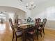 Elegant dining room with chandelier and adjacent to the living area at 3001 Lake Huron Ln, Tavares, FL 32778