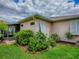 Charming home exterior with a screened-in patio and vibrant landscaping at 3001 Lake Huron Ln, Tavares, FL 32778