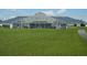 Exterior image showcasing the community pool area with well-kept lawns and an enclosed structure with ample seating at 3001 Lake Huron Ln, Tavares, FL 32778