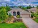 Aerial view of this single Gathering home featuring a two-car garage, mature trees and manicured landscaping at 3001 Lake Huron Ln, Tavares, FL 32778