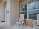 Cozy front porch seating area with white chairs, ideal for relaxing and enjoying the neighborhood views at 3001 Lake Huron Ln, Tavares, FL 32778