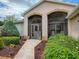 Inviting front porch with stone pathway and lush greenery, creating a welcoming entrance to the home at 3001 Lake Huron Ln, Tavares, FL 32778